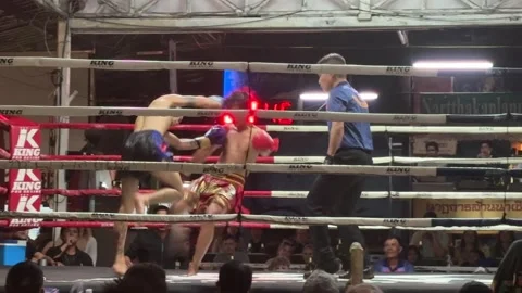 Muay Thai fighters fighting in ring with referee at Kalare Stadium Видео 331038374