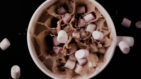 Much marshmallow falls into cocoa, top view. Slow mo Stock Footage 75312784