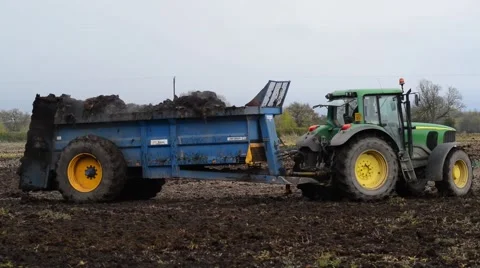 Muck spreading machine in field yorkshire united kingdom Stock Footage 62672696