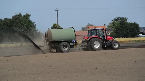 Muck spreading machine in field yorkshire united kingdom Stock Footage 78057673