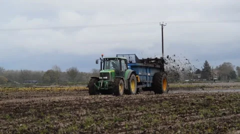 Muck spreading machine working in field yorkshire united kingdom Stock Footage 62673981