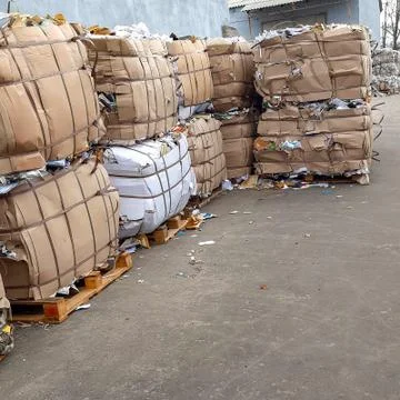 Mucolatura pressed into bales, stacked in a stack. waste paper Stock Photos