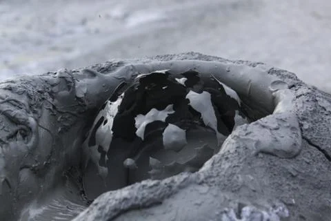 Mud bubble bursting in mud volcano Stock Photos