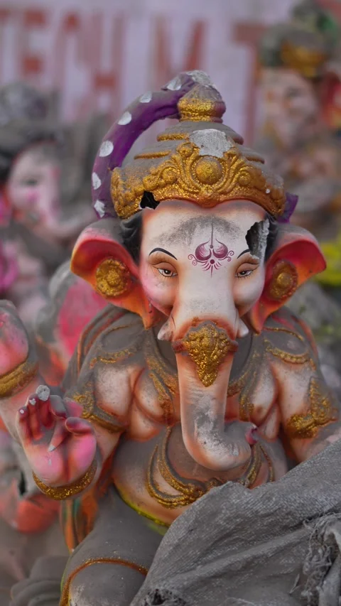 Mud-Covered Broken Ganesha Statue Lying on Urban Roadside in India Stock Footage 326360937