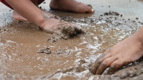Mud covered hands of a child.  Children playing in mud Stock Footage 304771495
