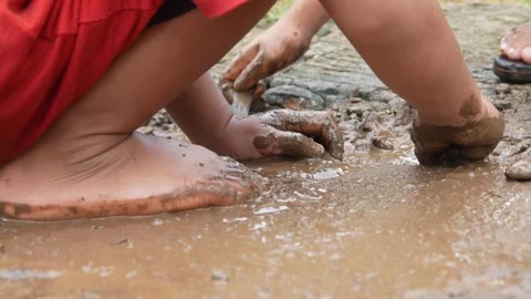 Mud covered hands of a child.  Children playing in mud Stock Footage 304771500