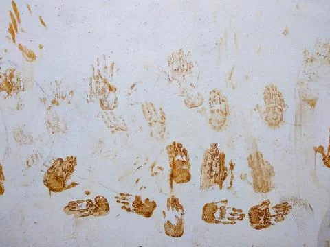 Mud handprint on the white wall Stock Photos