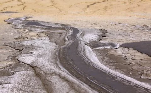 Mud lava flows downhill from mud volcano Stock Photos