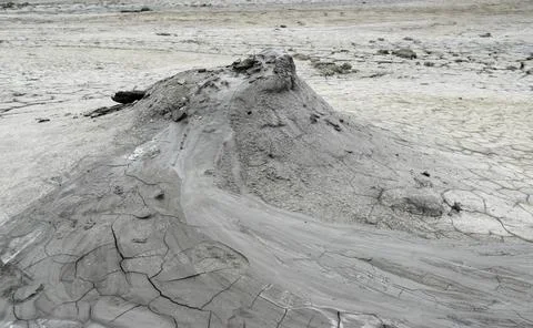 Mud liquid flowing from mud volcano, at Paclele Mari mud volcanoes in Buzau,  Stock Photos