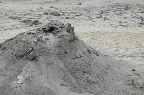 Mud liquid flowing from mud volcano, at Paclele Mari mud volcanoes in Buzau,  Stock Photos