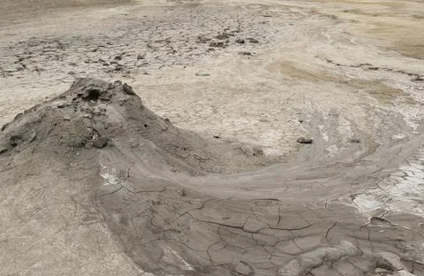 Mud liquid flowing from mud volcano, at Paclele Mari mud volcanoes in Buzau,  Stock Photos