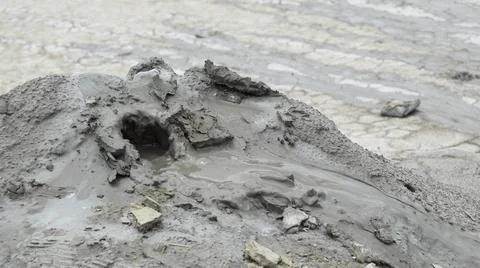Mud liquid flowing from mud volcano, at Paclele Mari mud volcanoes in Buzau,  Stock Photos