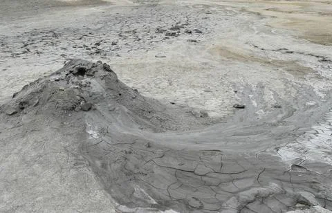 Mud liquid flowing from mud volcano, at Paclele Mari mud volcanoes in Buzau,  Stock Photos