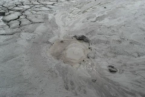 Mud liquid flowing from mud volcano, at Paclele Mari mud volcanoes in Buzau,  Stock Photos