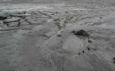 Mud liquid flowing from mud volcano, at Paclele Mari mud volcanoes in Buzau,  Stock Photos