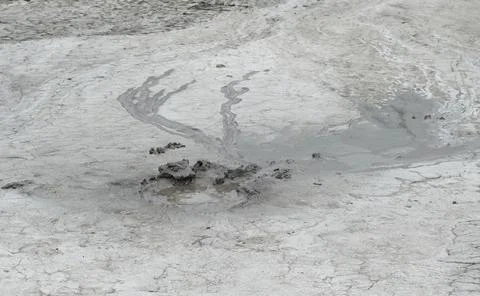 Mud liquid flowing from mud volcano, at Paclele Mari mud volcanoes in Buzau,  Stock Photos