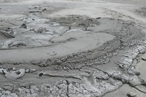 Mud liquid flowing from mud volcano, at Paclele Mari mud volcanoes in Buzau,  Stock Photos