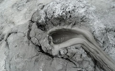 Mud liquid flowing from mud volcano, at Paclele Mari mud volcanoes in Buzau,  Stock Photos