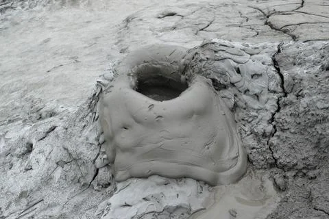 Mud liquid flowing from mud volcano, at Paclele Mari mud volcanoes in Buzau,  Stock Photos