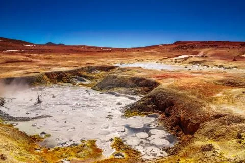 Mud pool by geyser Sol de la Manana in the Altiplano of Bolivia Stock Photos