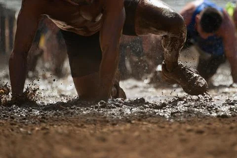 Mud race runners Stock Photos