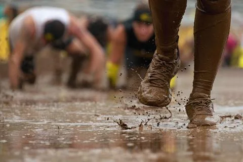 Mud race runners Stock Photos