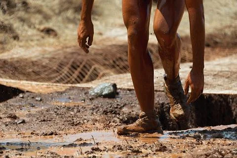 Mud race runners Stock Photos