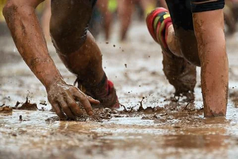 Mud race runners Stock Photos