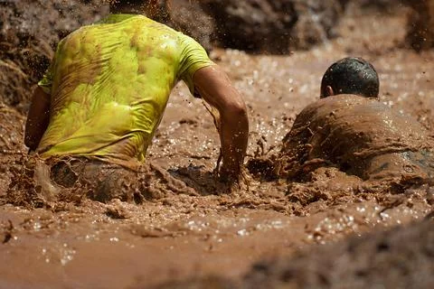 Mud race runners Stock Photos