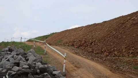 Mud roads between stone materials and brown rock hills Stock Footage 306560741