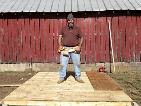 Mud stained workman standing on platform Stock Photos