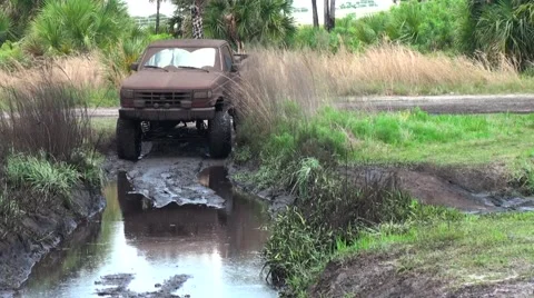 Mud truck getting stuck in the mud Stock Footage 64182081