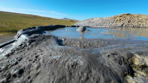 Mud volcano. Always active mud volcanoes surrounded by mountains Stock Footage 277669657