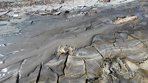 Mud volcano. Always active mud volcanoes surrounded by mountains Stock Footage 277669659