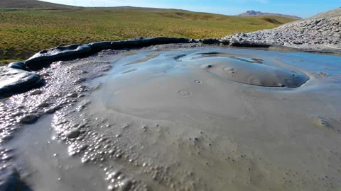 Mud volcano. Always active mud volcanoes surrounded by mountains Stock Footage 277669746