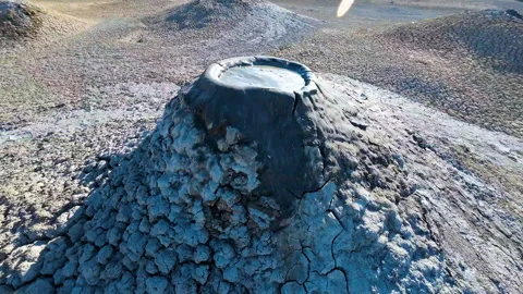 Mud volcano. Always active mud volcanoes surrounded by mountains Stock Footage 277669800