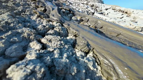 Mud volcano. Always active mud volcanoes surrounded by mountains Stock Footage 277669937