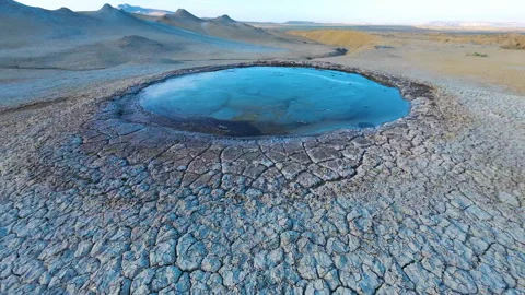 Mud volcano. Always active mud volcanoes surrounded by mountains Stock Footage 277670232
