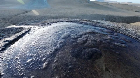 Mud volcano. Always active mud volcanoes surrounded by mountains Stock Footage 277670371