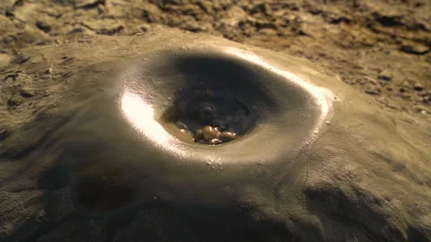 Mud volcano. Always active mud volcanoes surrounded by mountains Stock Footage 277670470