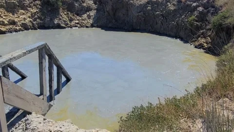 Mud volcano Hephaestus. The Pool with volcanic mud and ladder to go down in mud Stock Footage 300330186
