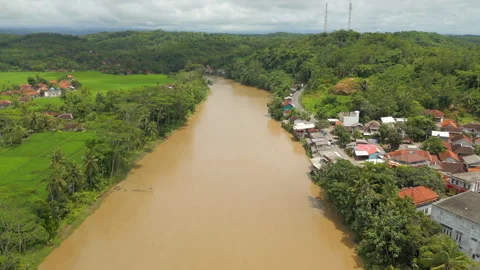 Muddy Brown River In Java Indonesia Sindangbarang Drone Rise 4K 60FPS Stock Footage 334306007