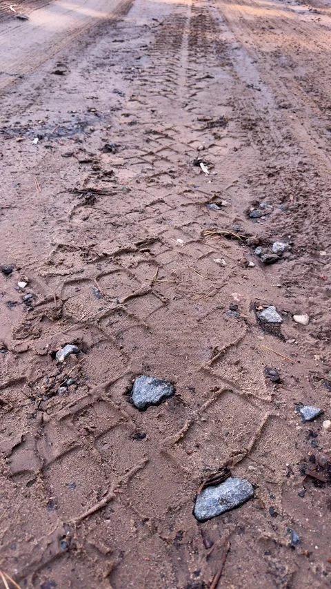 Muddy dirt road with deep tire tracks and small stones. Off-road terrain Видео 339366475