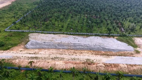 Muddy drainage ditch runs parallel Stock Footage 347939735