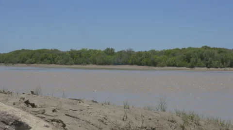 Muddy East Alligator River flows on through Kakadu, Australia Stock Footage 68940359