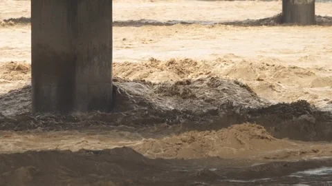 Muddy flood waters between bridge columns Stock Footage 123323662