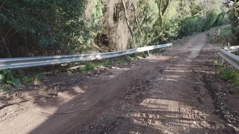 Muddy Mountain Forest Road with Barriers After Heavy Rainfall in Remote Area Stock Footage 338105183