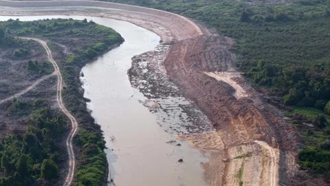 Muddy river bends through cleared land Vidéo 337723026