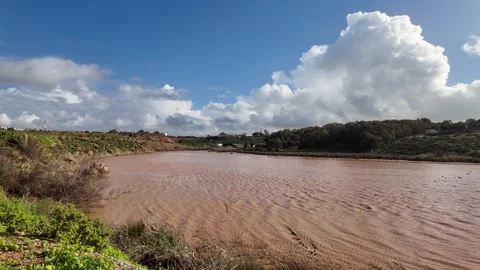 Muddy river landscape under dramatic clouds in Skhirat, Morocco January 4, 2026 Video stock 334056091