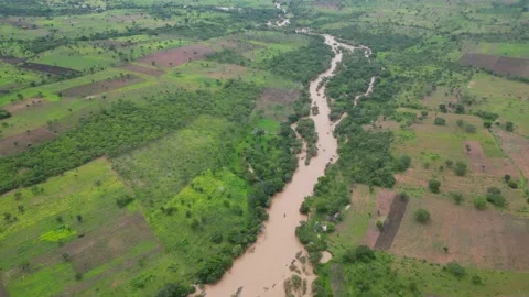Muddy river running through rural villages in Tanzania, Africa Stock Footage 235447083